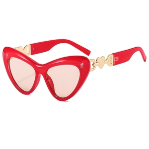 Fashionable red heart-shaped sunglasses with pink lenses and gold-tone metal heart temples