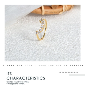 Close-up of curved 18k gold plated ring featuring seven graduated sparkling cubic zirconia stones
