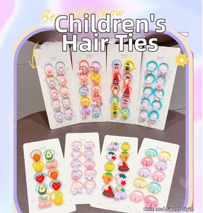 Detail of multi-color kids elastic hair ties with fruit and flower charms on display cards