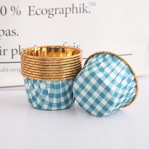 Close-up of heat-resistant blue and white checkered cupcake liners with elegant gold rims