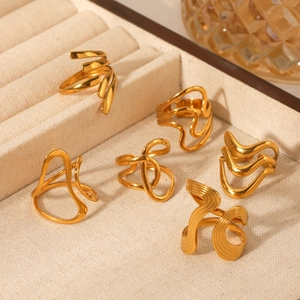 Close-up of set of 6 gold plated 18K stainless steel rings with abstract wavy designs
