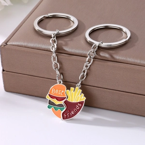 Macro view of burger and fries magnetic heart pendants with Best Friends engraving