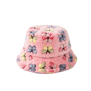 Plush pink bucket hat with colorful butterfly patterns for winter warmth and fashion