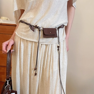 Detail of vintage brown fabric beaded belt featuring a mini PU leather purse attachment