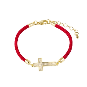 Detail of red Milan rope bracelet with gold cross charm micro-paved in zircon stones