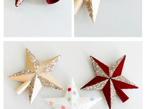 Close-up of glittery Christmas tree star toppers with beaded details and velvet texture