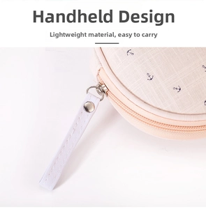 Detail of round fabric travel pouch with blue anchor pattern and sturdy wrist strap