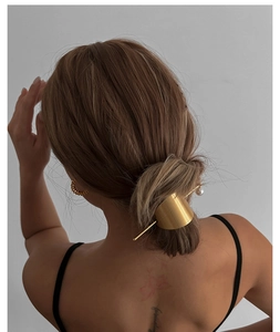 Minimalist gold semi-circle hair pin with white pearl accent for elegant updos