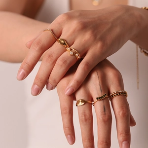 French style 18K gold stainless steel ring set with zircons and pearls on female hands