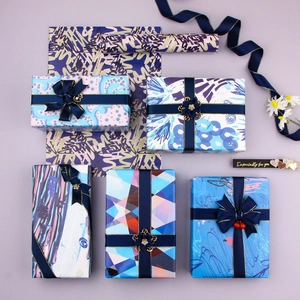 Artistic gift wrapping paper set with geometric patterns, ribbons and decorative bows