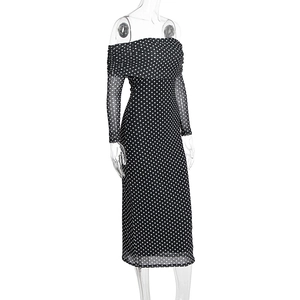 Detail of off-the-shoulder neckline and mesh polka dot fabric on a slim black midi dress