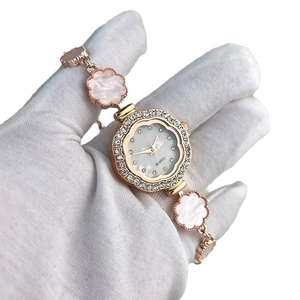 Women's rose gold quartz watch with rhinestone bezel and floral petal link bracelet