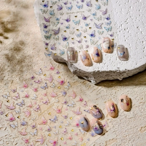 Luxury 3D butterfly nail stickers with gold foil edges on aesthetic stone display