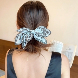 Classic French blue paisley bow hair clip on model for a sophisticated ponytail look