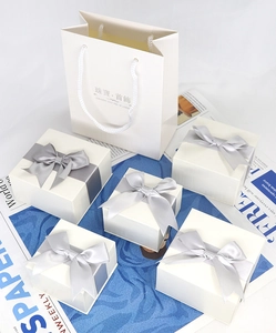 White jewelry gift boxes with silver-grey satin bows and matching carry bag set