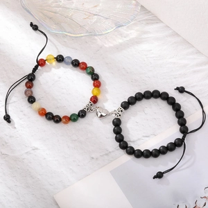 Detail of heart magnet clasp connecting tiger eye and matte stone bead bracelets