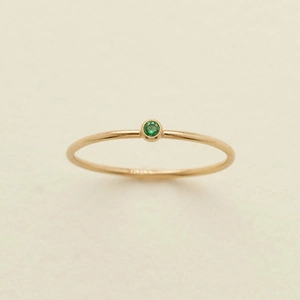 Minimalist gold ring with green December birthstone in a bezel setting for women