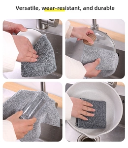 Close-up of grey bamboo fiber cloths cleaning ceramic bowls and glass kitchenware