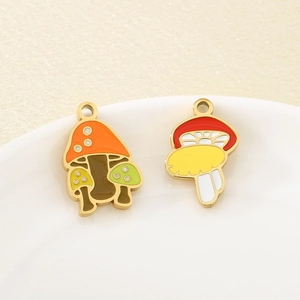 Close-up of colorful enamel mushroom pendants made of stainless steel for DIY jewelry