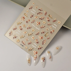 Autumn Magnolia 5D embossed nail stickers with gold foil details and floral patterns