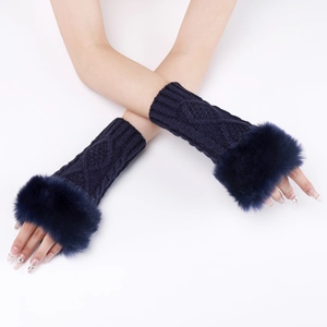 Detail of dark blue cable knit arm warmers with thick faux fur trim and fingerless design