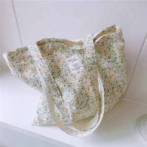 Close-up of floral cotton tote bag showing fabric texture and woven label detail