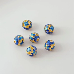 Detailed view of six 18K gold-plated cloisonne beads with blue floral enamel patterns