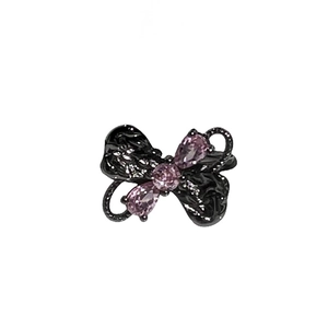 Elegant black butterfly ring with pink gemstones on a clean white background