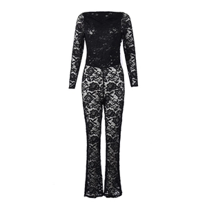 Detailed close-up of intricate floral lace texture on a black long-sleeve jumpsuit