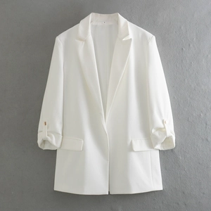 Detail of white minimalist blazer featuring rolled sleeves and a small S size label on the neck