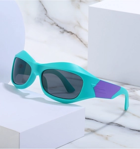 Close-up of Y2K cycling sunglasses with blue frames on white geometric podiums