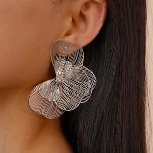 Silver hollow flower earrings with layered petals in a minimalist metallic floral style