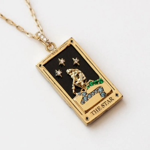Detail of The Star Tarot pendant with black enamel, gold plating and colorful gemstones