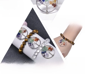 Detail of tree of life charm and multi-color gemstone beads on a stretch bracelet