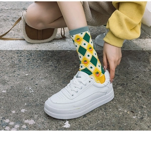 Close-up of diamond pattern cotton socks with strawberry embroidery on feet