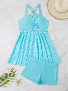 Detailed view of light blue two-piece swimsuit with lace skirt and starfish decor