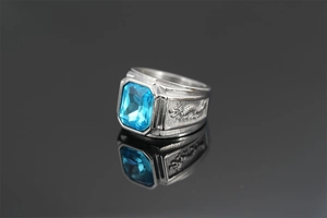 Detailed close-up of double dragon ring with rectangle blue gemstone and silver finish
