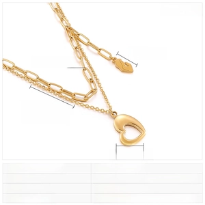 Double-layered gold stainless steel necklace with heart pendant and face outline charm
