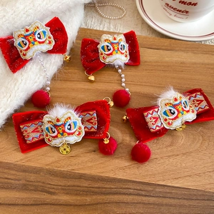 Detail of red velvet hair clips with Chinese traditional dancing lion embroidery and pearls