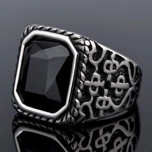 Macro shot of vintage men's silver stainless steel ring featuring a faceted black gemstone