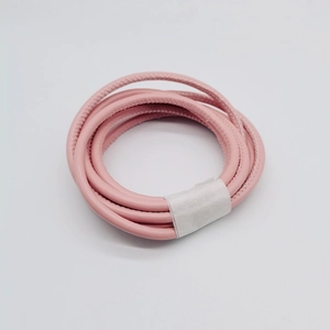 Close-up of 6mm pink PU leather cord with side stitching for DIY handbag straps