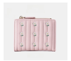 Front view of pink faux leather wallet with vertical quilting and small daisy embroidery
