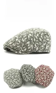 Detailed close-up showing vintage floral patterns on grey and red flat caps for men and women