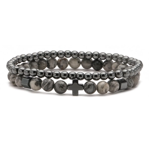 Detail of natural stone bead bracelets with hematite beads and marble cross pendant