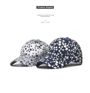 Detail show of navy and white cotton baseball caps with all-over star pattern prints