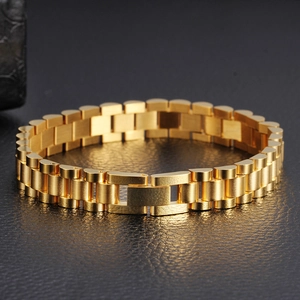 Polished gold stainless steel watchband link bracelet for men on black textured surface