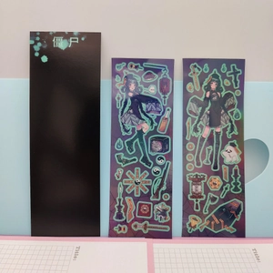 Detail of dark anime zombie stickers with glowing green outlines on grid paper
