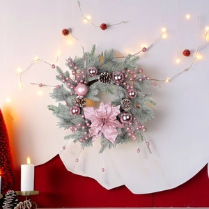Pink Christmas wreath with flocked pine needles, silver ornaments, and a glittery flower