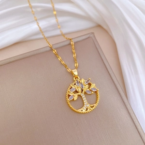 Elegant Tree of Life necklace in gold finish with sparkling crystals on satin background
