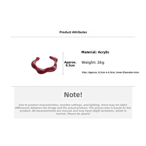 Detail view of irregular red acrylic bangle with dimensions 8.5x6.5cm weighing 26g